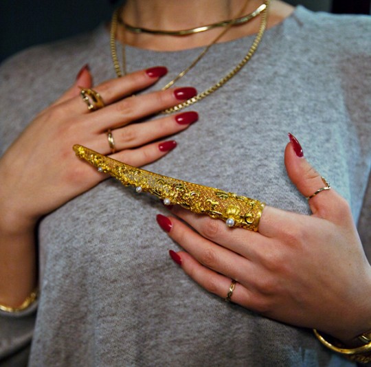 Karla Deras red nails gold jewellery